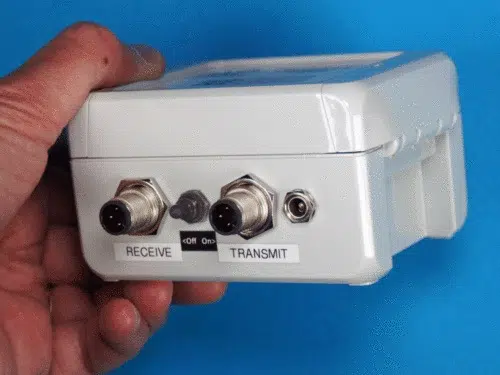 hand holding production counter timer wireless sensor showing bottom view by Leap Sensors