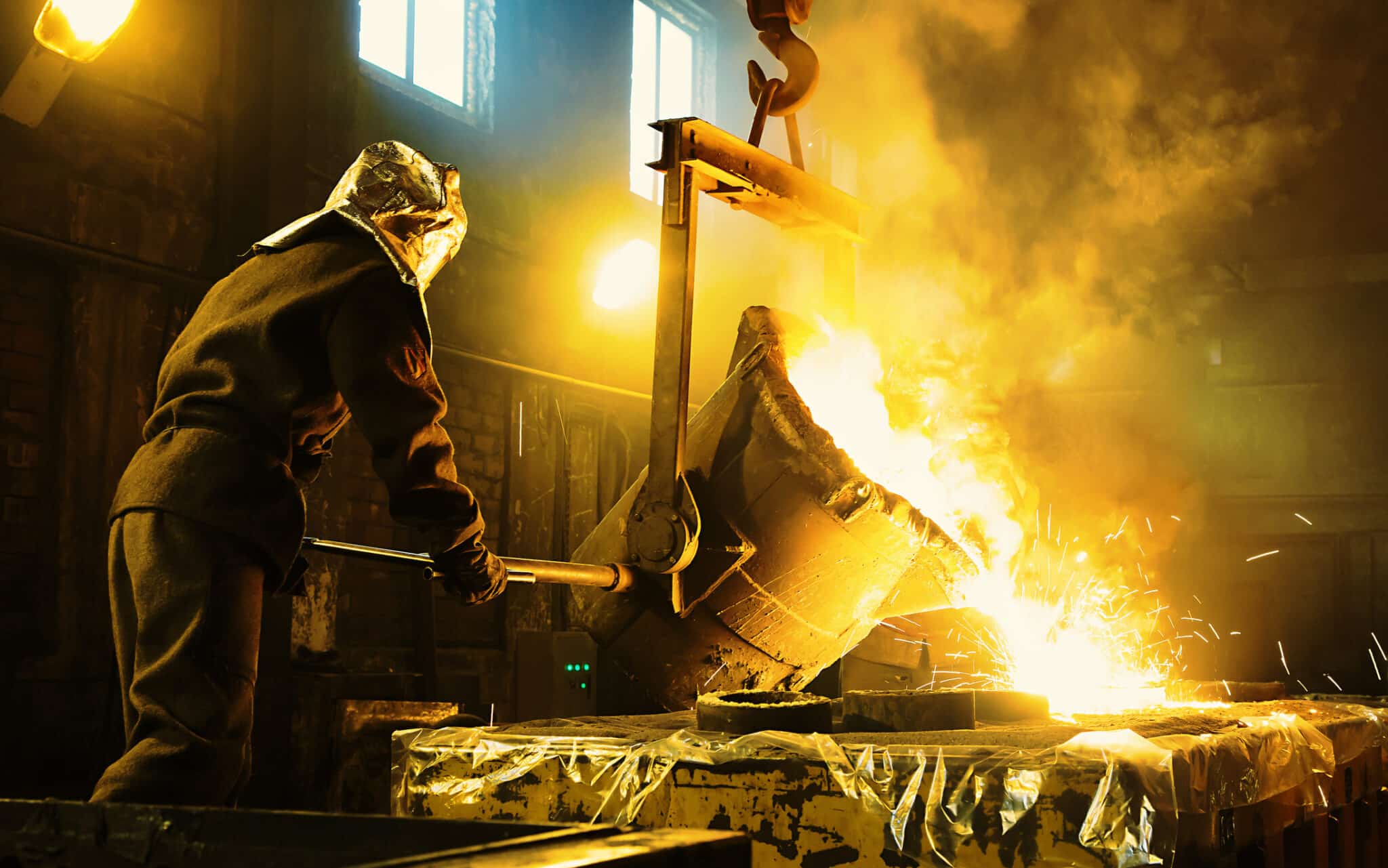 Worker controlling metal melting in furnaces. Workers operates at the metallurgical plant. Worker controlling metal melting in furnaces. Workers operates at the metallurgical plant.